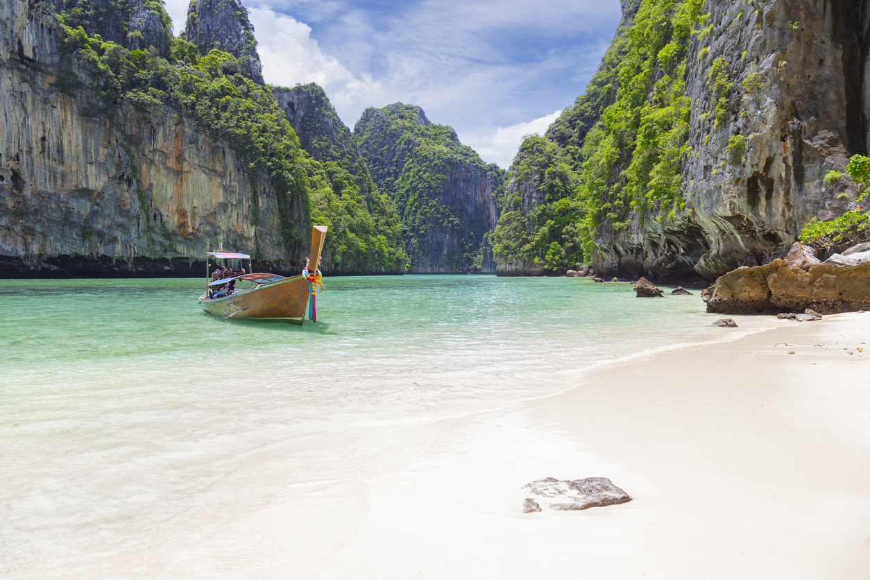The Thai traditional wooden longtail boat and beautiful beach in Phuket province, Thailand.
