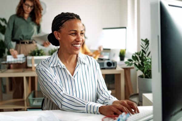 Well dressed smiling businesswoman working at the office